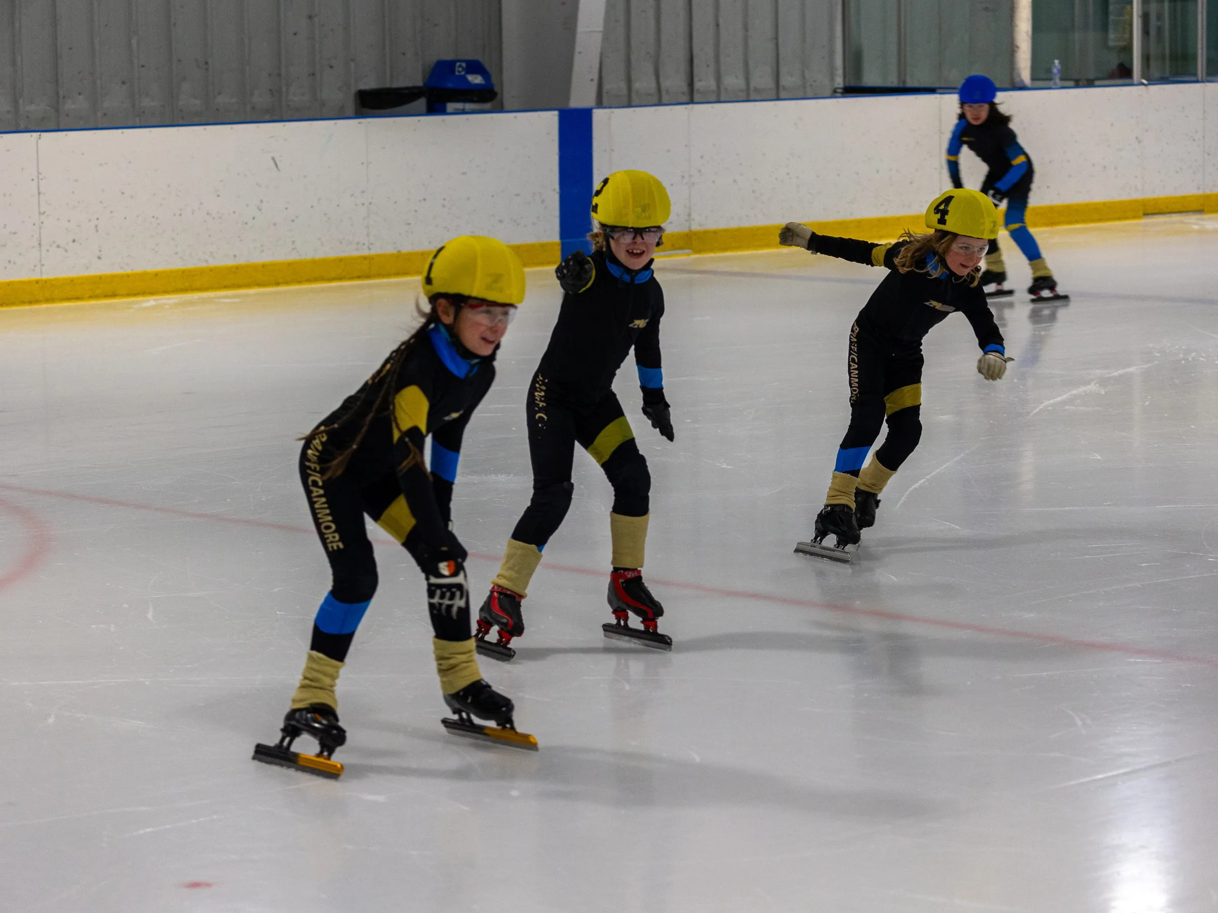 Young skaters spread out across the ice during a session