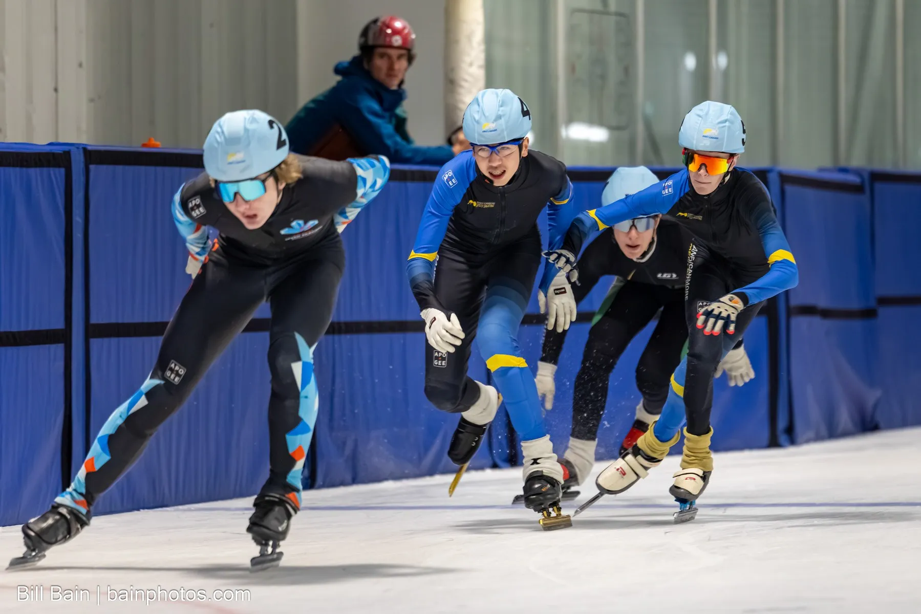 Club skaters leaning through a corner during a race
