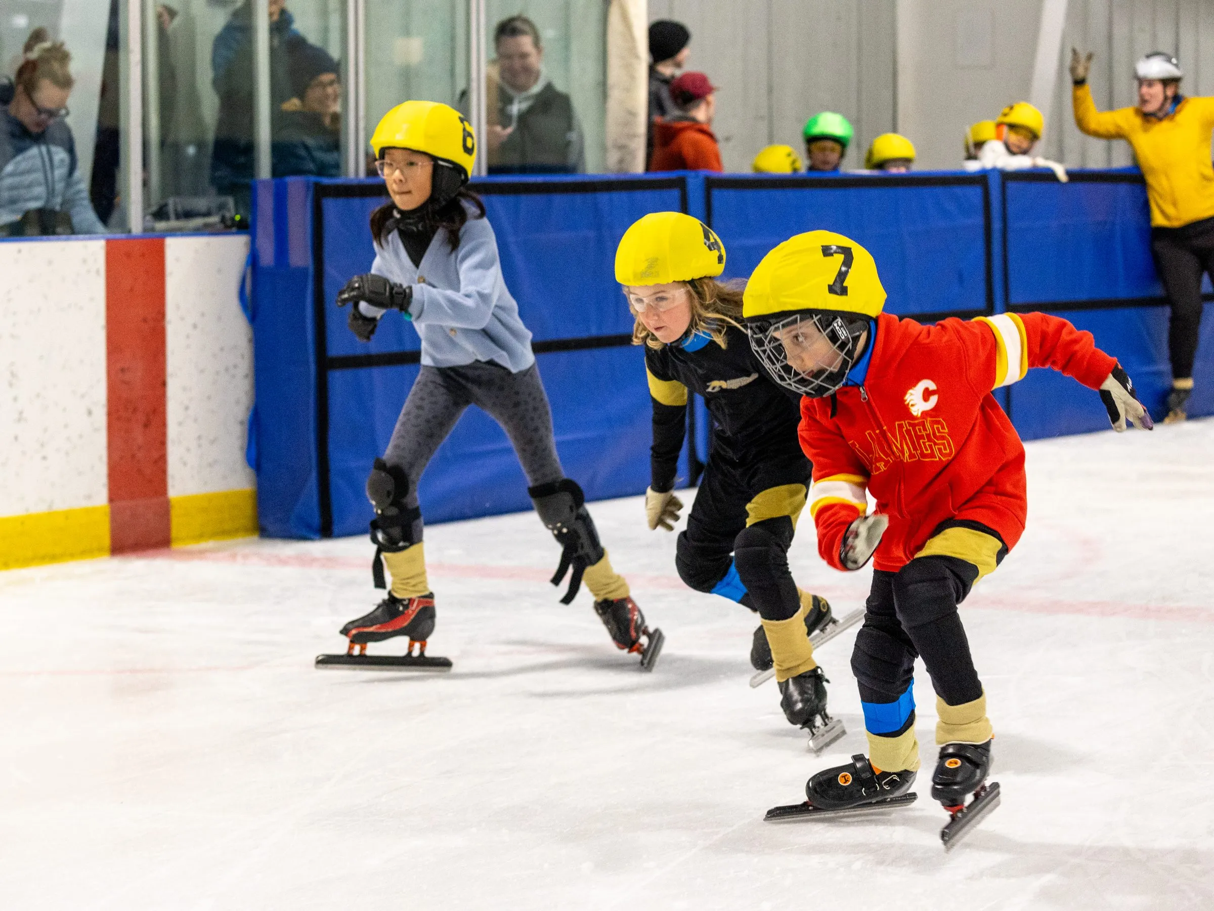 Young skaters of mixed ages and abilities racing together