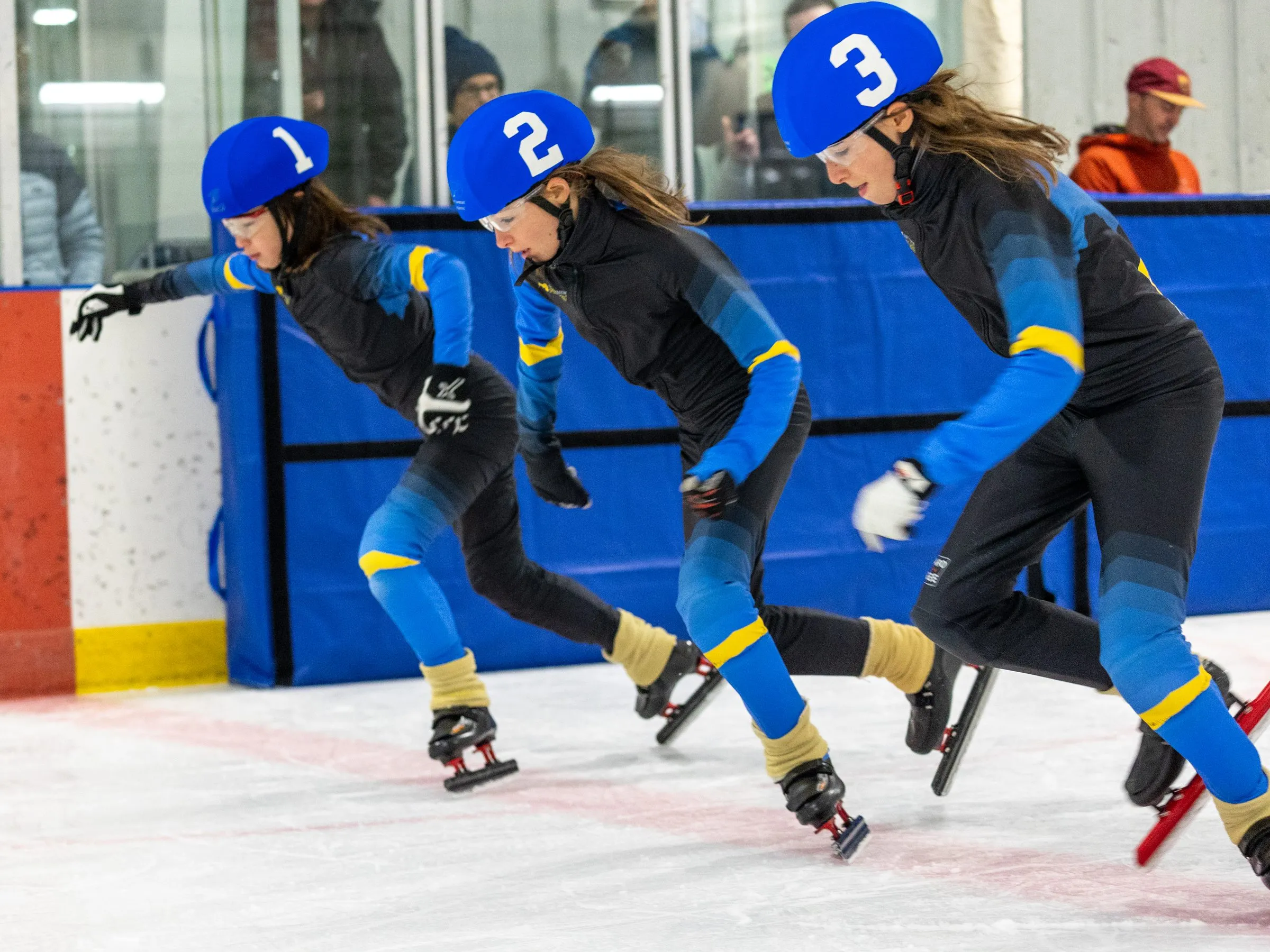 Three club skaters driving out of the start at a club race