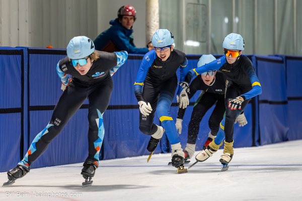 A pack of skaters leaning through a corner