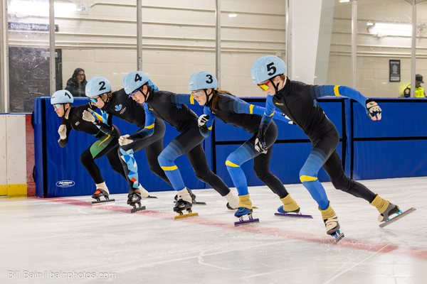 Five skaters driving off the start line