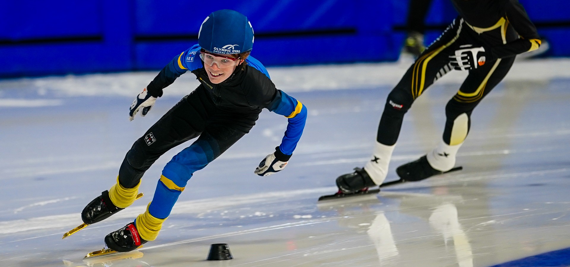 Skaters racing on ice at a club meet